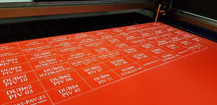 Engraved fire system valve and hydrant identification labels, freshly cut